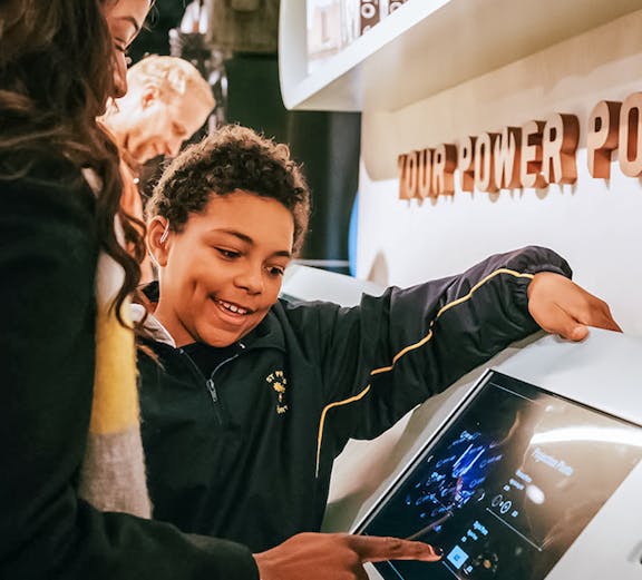 Visitors interacting with a digital display at Lift 109 exhibit.
