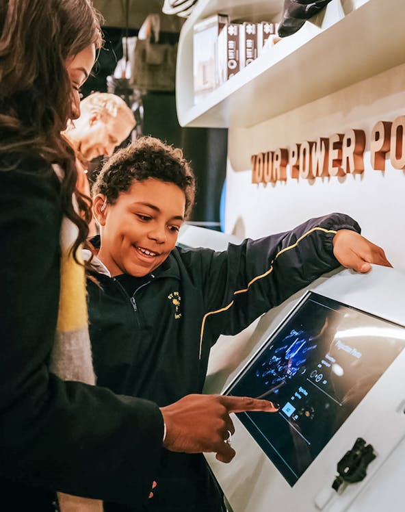 Visitors interacting with a digital display at Lift 109 exhibit.