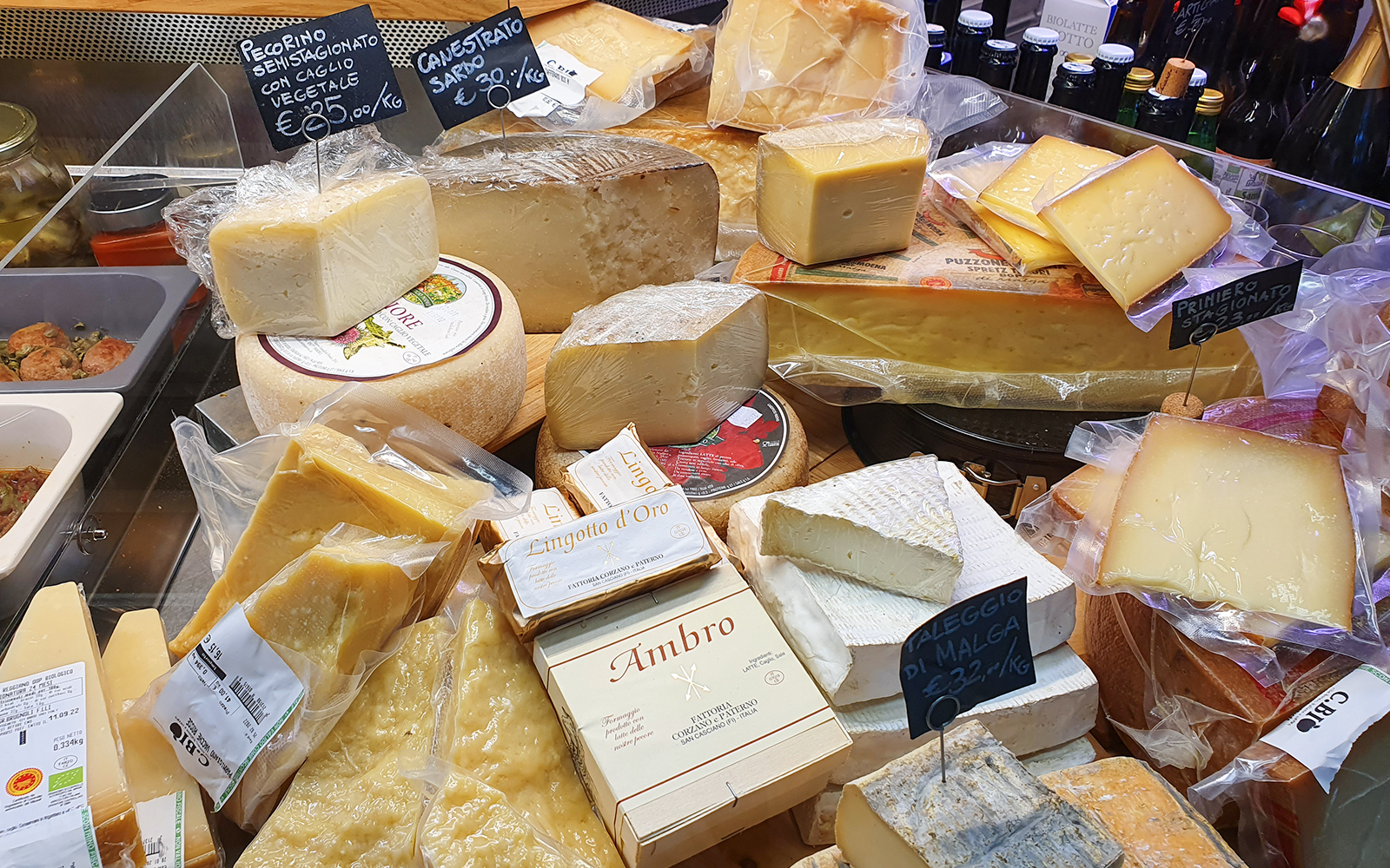 Assorted Italian cheeses on display at a Florence market during a food tour.