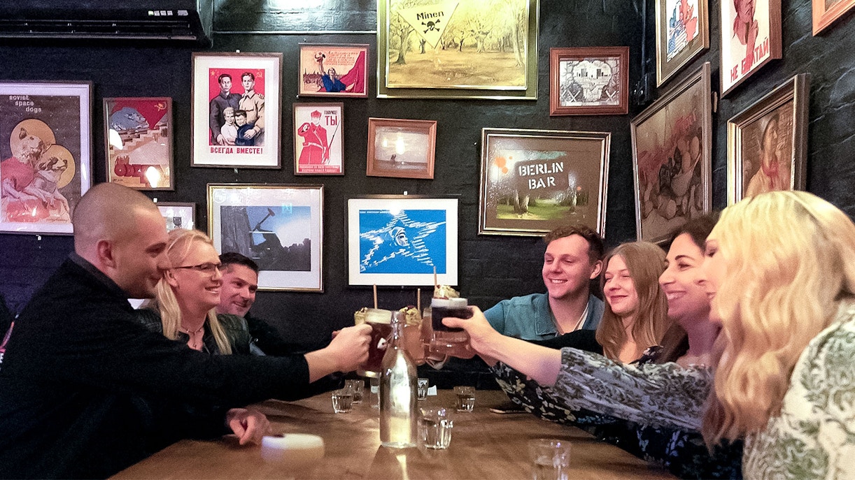 Group enjoying drinks at a hidden bar in Melbourne during a guided cocktail tour.