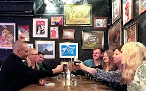 Group enjoying drinks at a hidden bar in Melbourne during a guided cocktail tour.