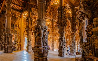 Sanctuary of Truth interior with intricate wooden carvings, Pattaya city tour.