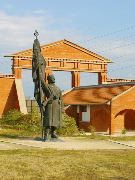 Statue and brick structures at Memento Park, Budapest.