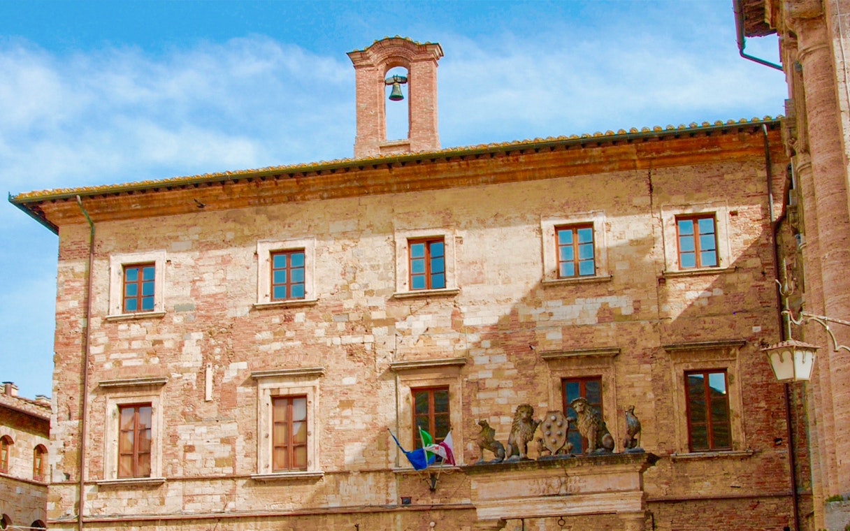 Historic building facade with bell tower in Tuscany, Italy, part of the Best of Tuscany in One Day tour.