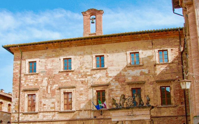 Historic building facade with bell tower in Tuscany, Italy, part of the Best of Tuscany in One Day tour.