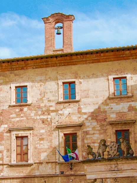 Historic building facade with bell tower in Tuscany, Italy, part of the Best of Tuscany in One Day tour.