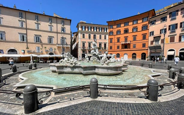 Fountain of Neptune in Piazza Navona, Rome, with surrounding historic buildings.