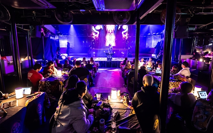 Audience watching a live performance blending samurai and kabuki elements in a Tokyo theater.