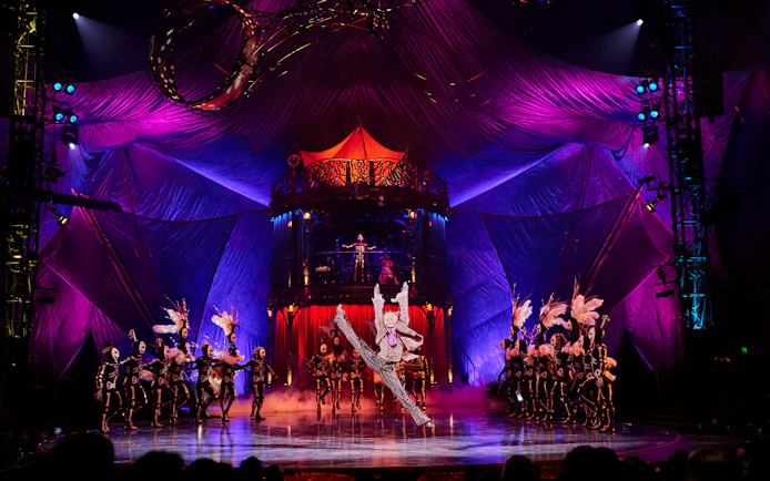 Acrobats performing at Kooza show in Brisbane with vibrant stage and costumes.