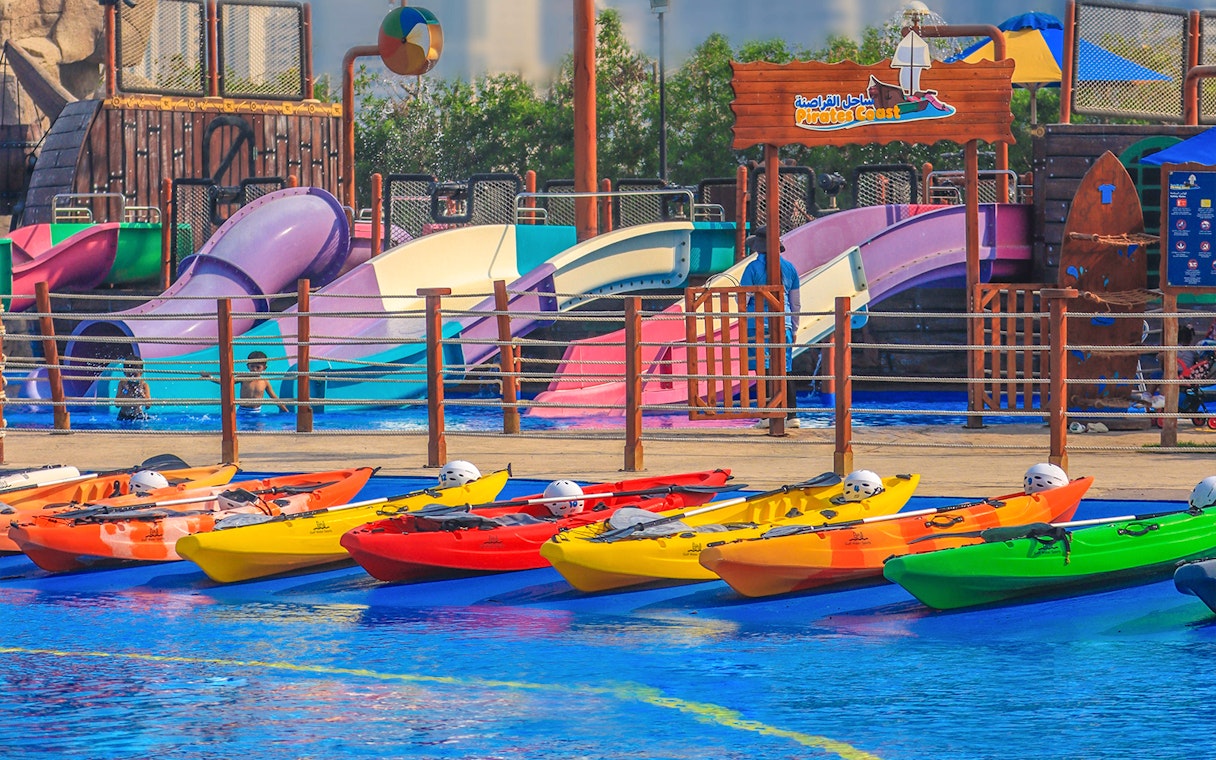 Colorful kayaks and water slides at Al Montazah Water Park, Sharjah.