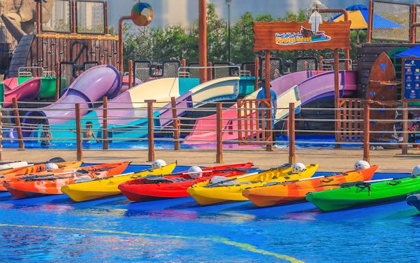 Colorful kayaks and water slides at Al Montazah Water Park, Sharjah.