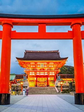 Fushimi Inari Shrine entrance with large red torii gate in Kyoto, Japan.