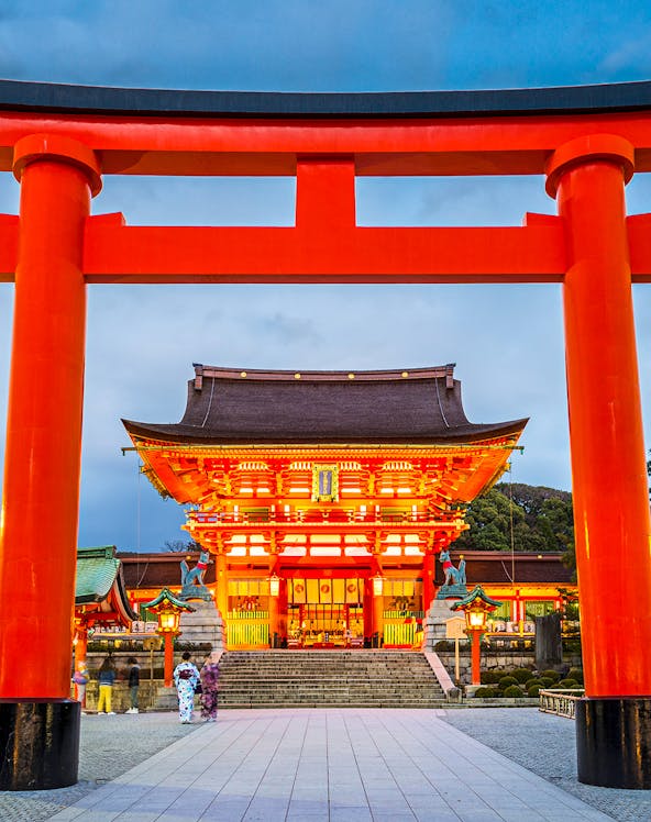 Fushimi Inari Shrine entrance with large red torii gate in Kyoto, Japan.