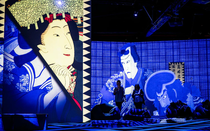 Japanese art projections at Rotterdam: Remastered exhibit with visitors observing.