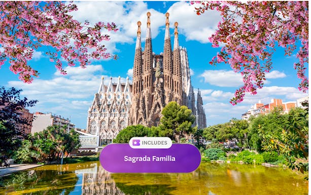 Sagrada Familia in Barcelona with blooming trees and reflection in pond.