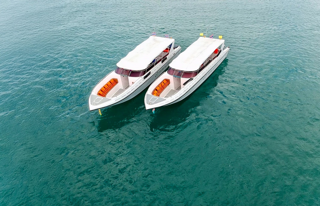 Speedboat approaching Phi Phi Island with limestone cliffs, part of Maya Bay and Bamboo Island tour from Phuket.