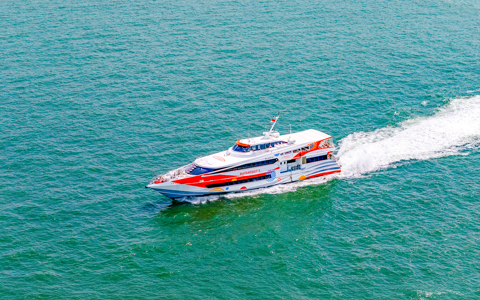 Ferry traveling from Singapore to Batam across the sea.