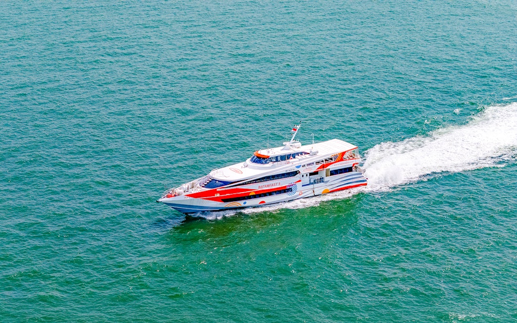 Ferry traveling from Singapore to Batam across the sea.