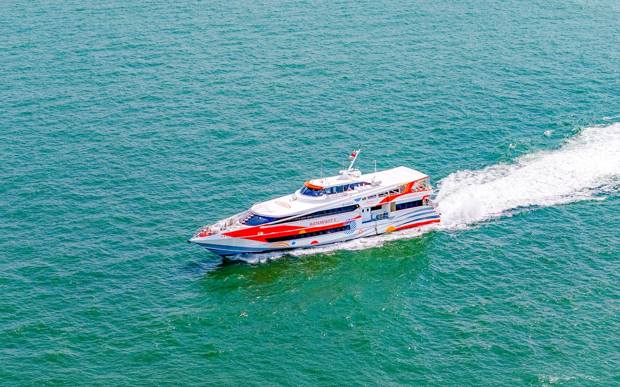 Ferry traveling from Singapore to Batam across the sea.