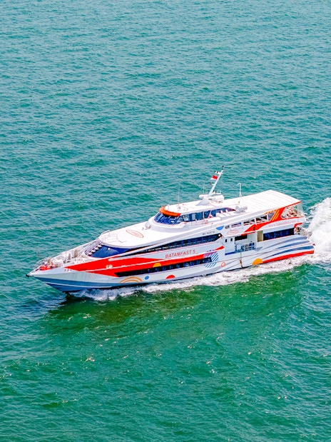 Ferry traveling from Singapore to Batam across the sea.