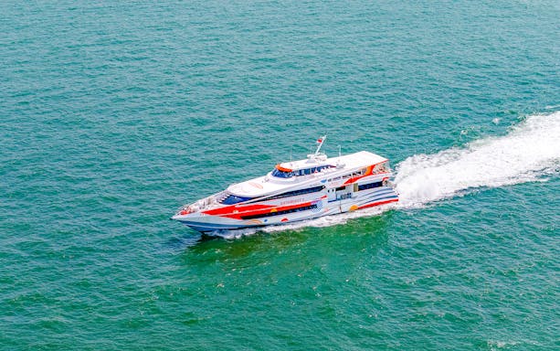 Ferry traveling from Singapore to Batam across the sea.
