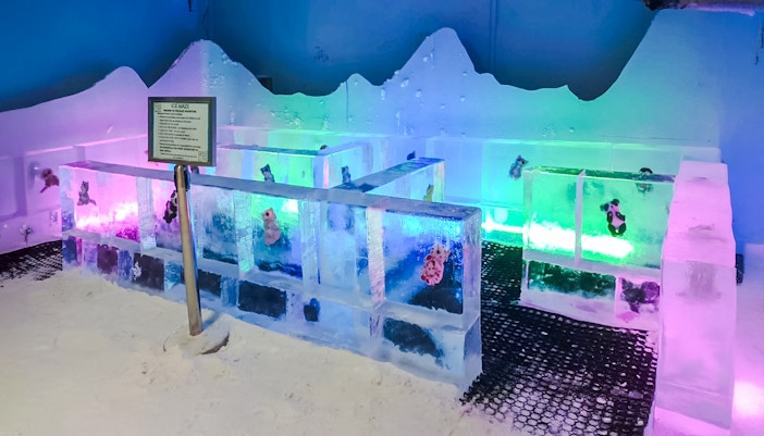 Ice maze with colorful lights and ice walls at Snow Village
