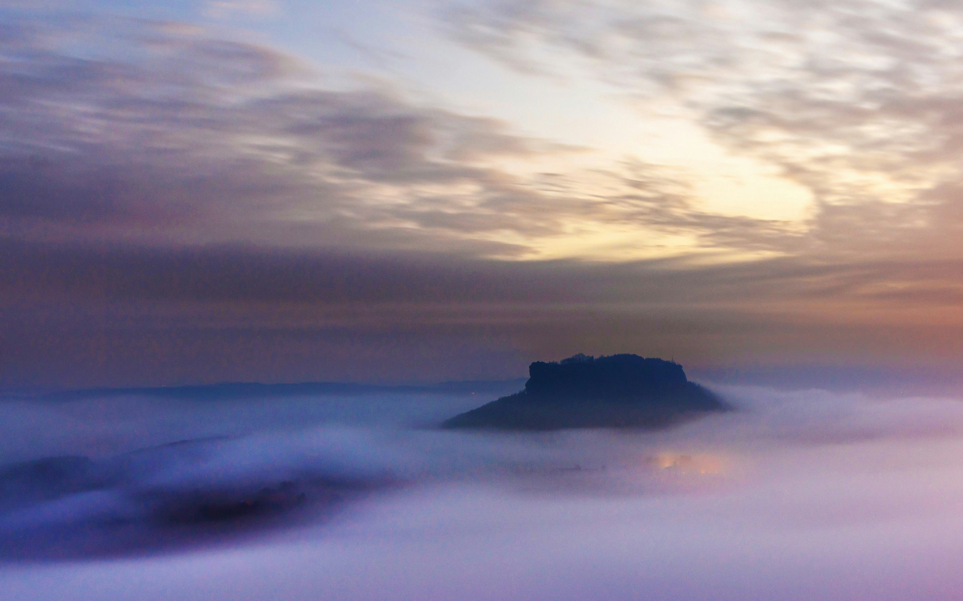 Aerial view of Mountain Lilienstein shrouded in mist at dawn, Saxon Switzerland, Germany.
