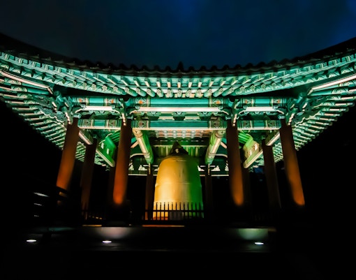 Bosingak Pavilion illuminated at night during the bell-ringing ceremony in Seoul, South Korea.