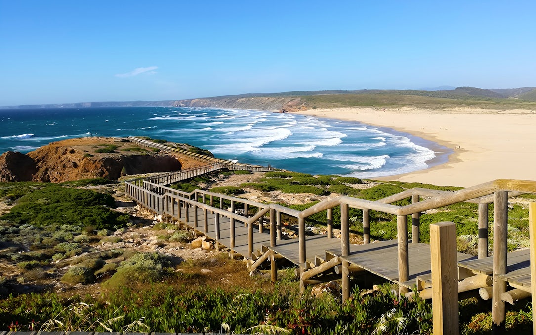 Wooden walkway overlooking beach and ocean at Vicentina Coast, Southwest Alentejo Natural Park.