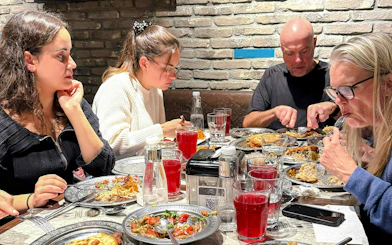 Group enjoying traditional Turkish dinner with assorted dishes in Istanbul restaurant.