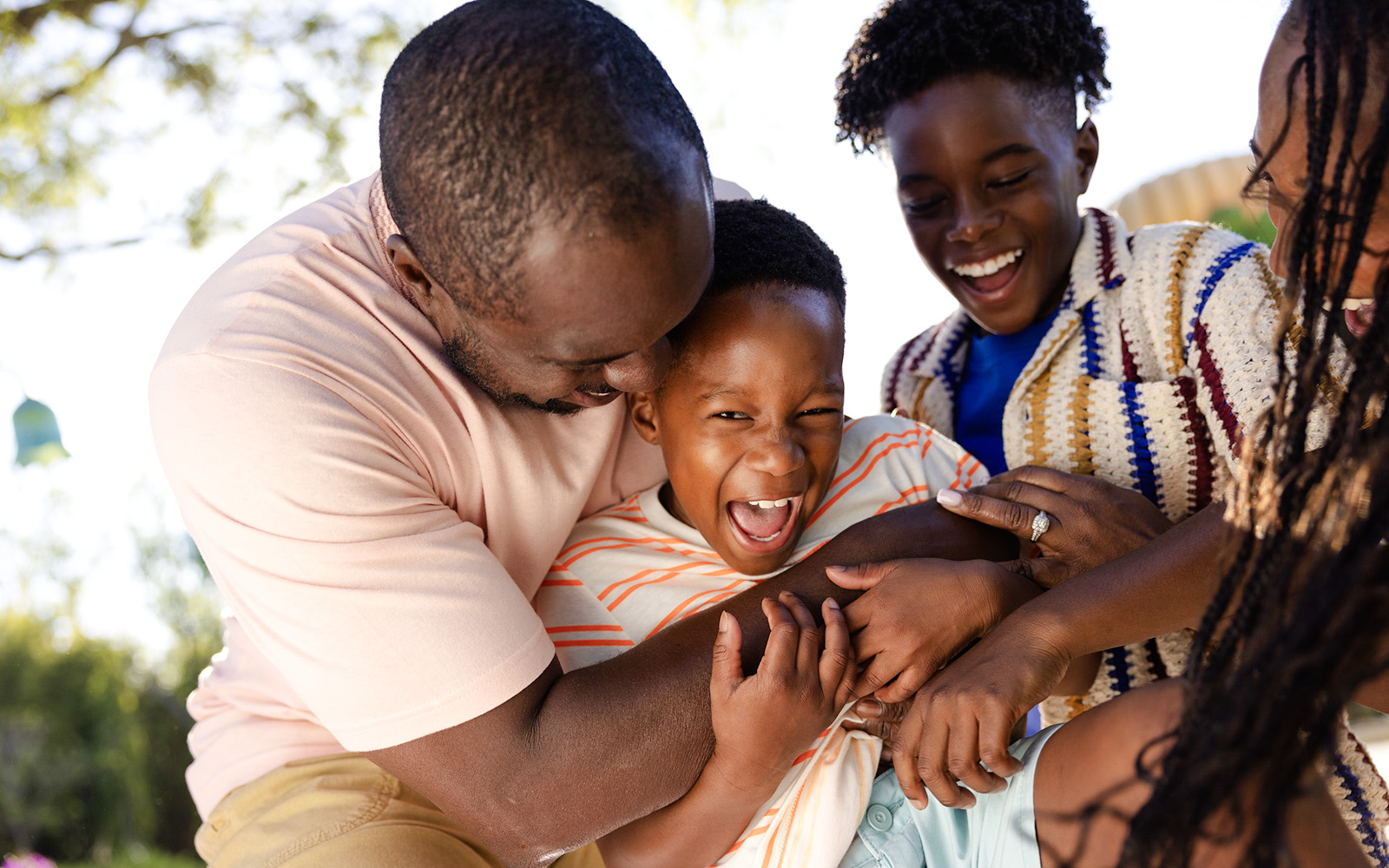Family enjoying playful moment at Universal Kids Resort.