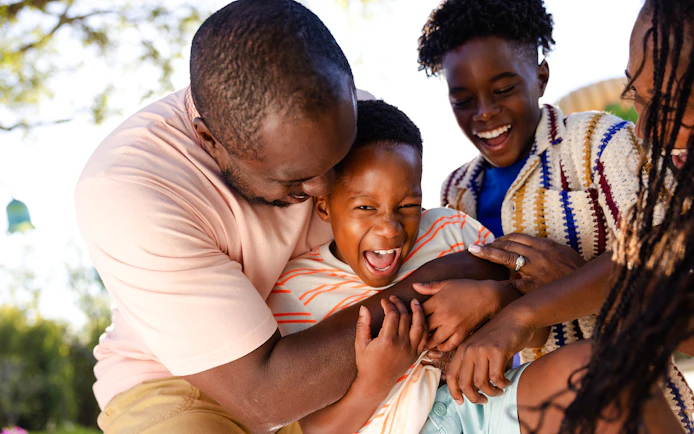 Family enjoying playful moment at Universal Kids Resort.