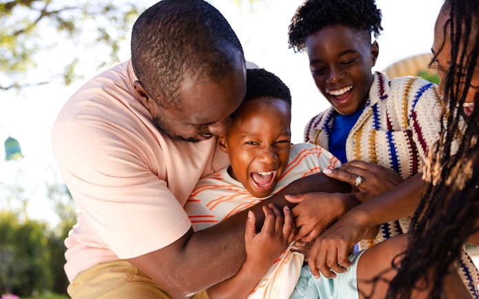 Family enjoying playful moment at Universal Kids Resort.