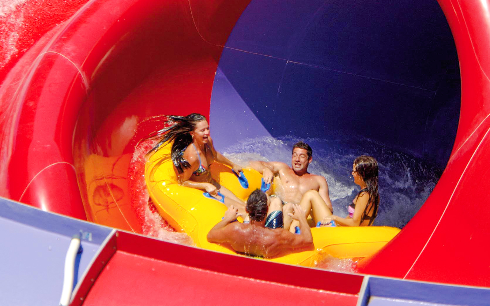 Group enjoying The Rip water slide at Whitewater World, Gold Coast.