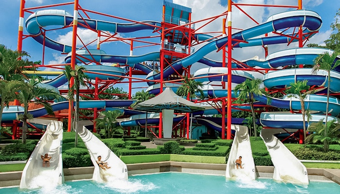 Super Spiral ride at Siam Amazing Park, Bangkok, featuring colorful water slides and excited visitors.