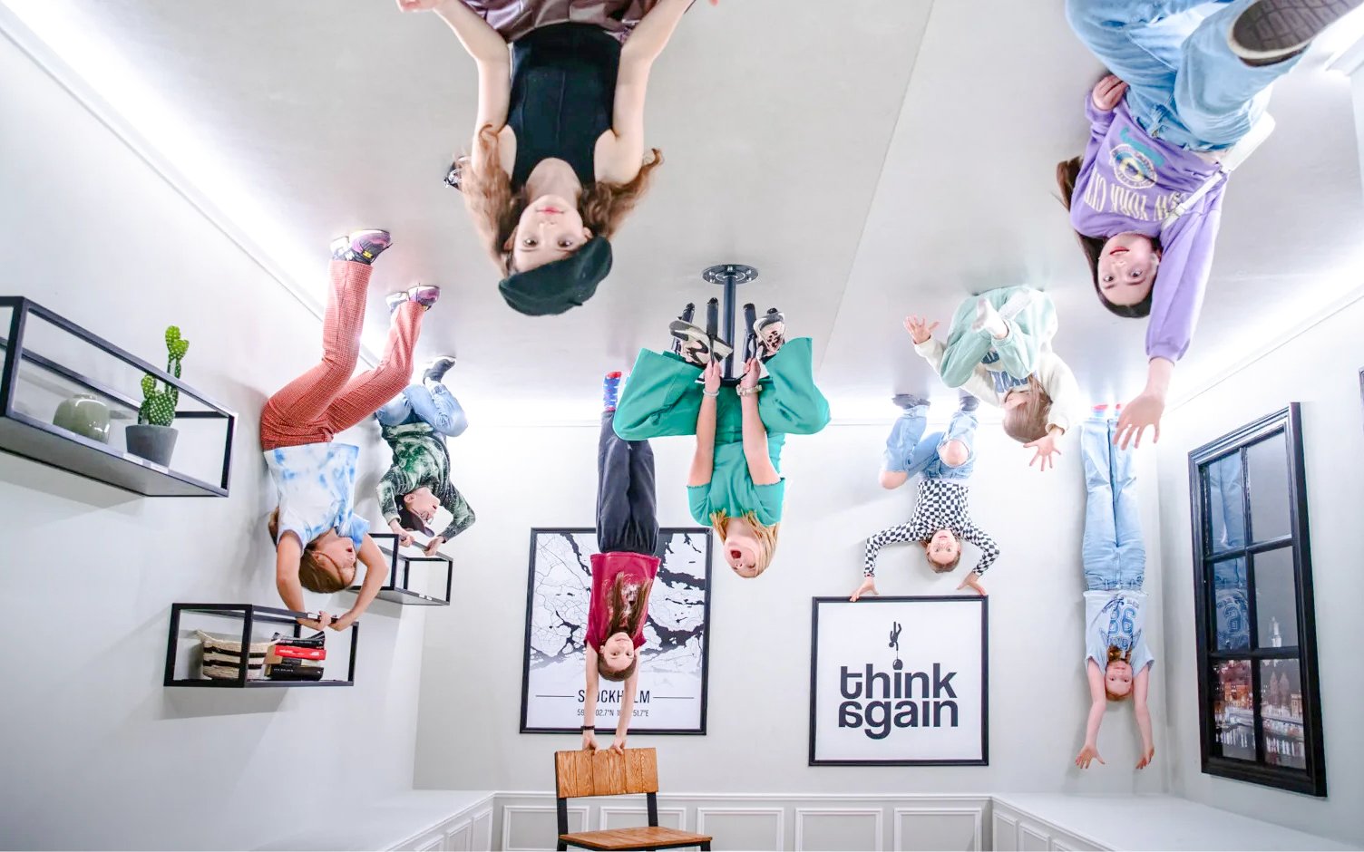 Visitors exploring the Paradox Museum Upside Down House exhibit.