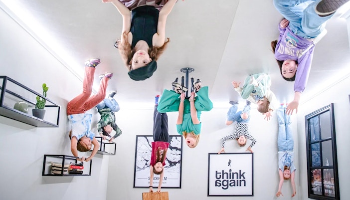 Visitors exploring the Paradox Museum Upside Down House exhibit.