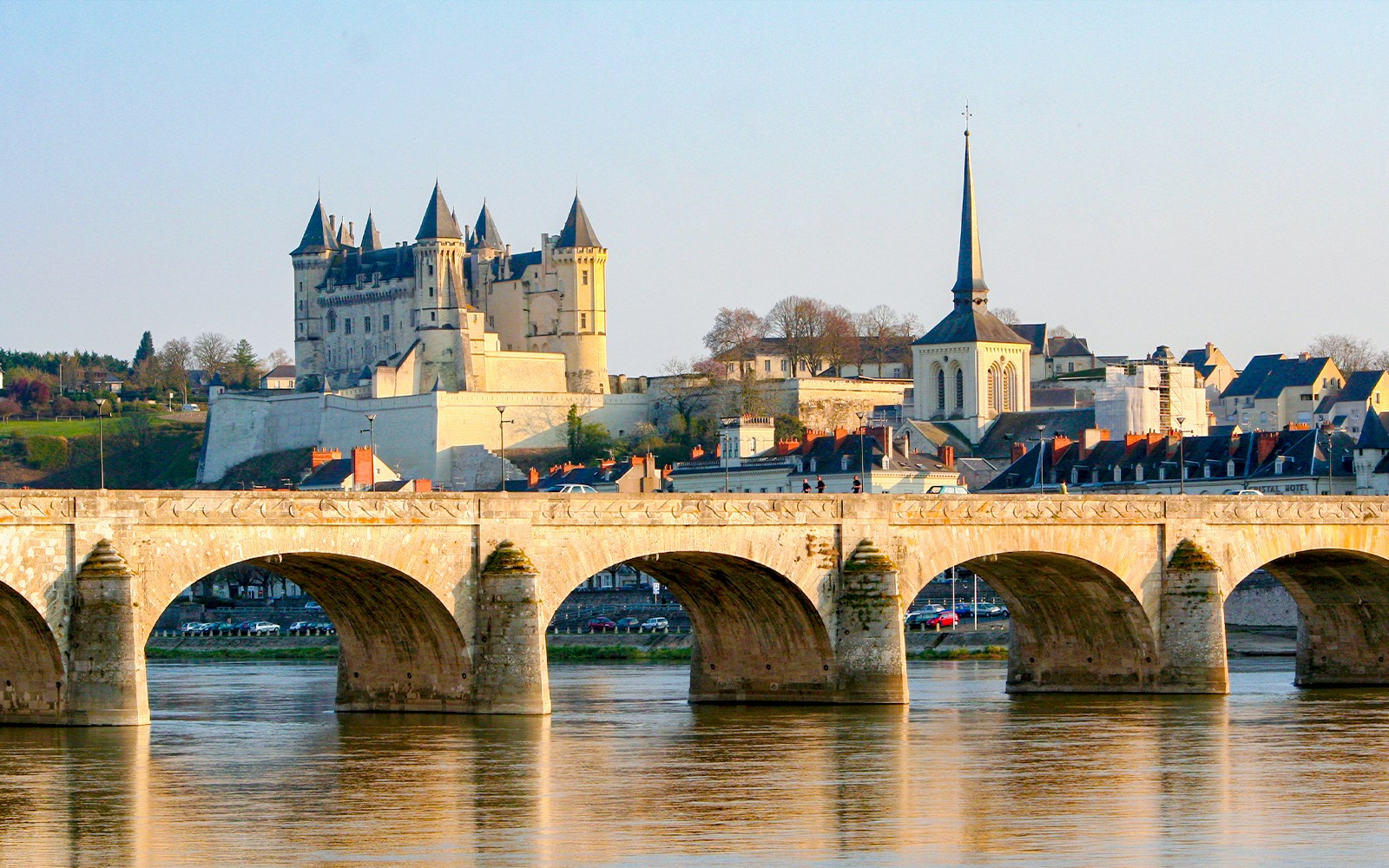 Saumur town bridge and Château de Saumur over the Loire River in France.