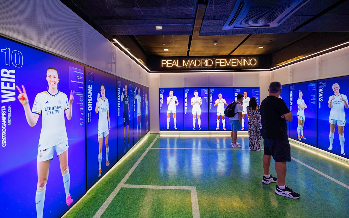 Real Madrid women's team display room in Madrid with digital player profiles.