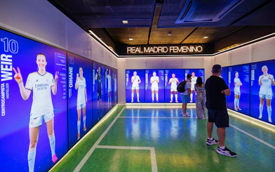Real Madrid women's team display room in Madrid with digital player profiles.
