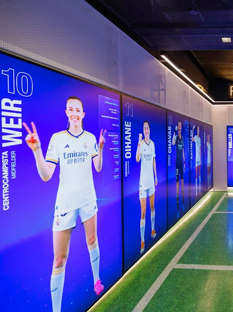 Real Madrid women's team display room in Madrid with digital player profiles.