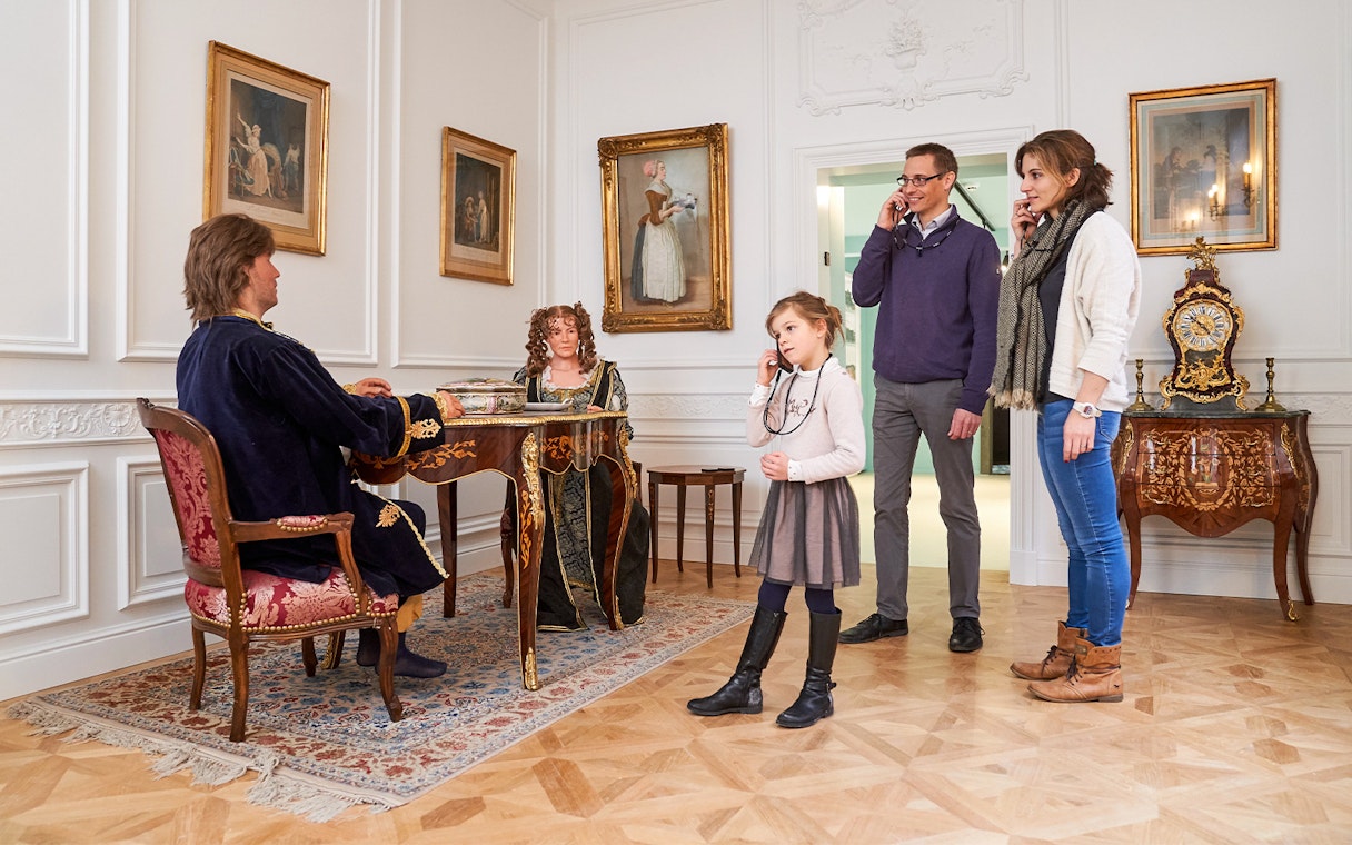 Tourists listening to an audio guide at Choco Story museum in Brussels.