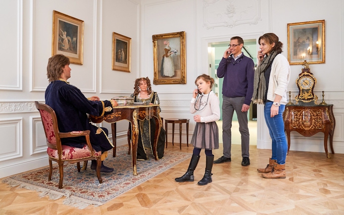 Tourists listening to an audio guide at Choco Story museum in Brussels.