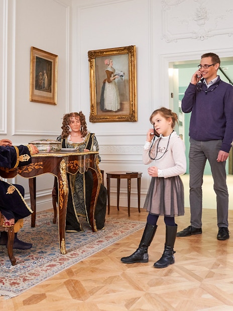 Tourists listening to an audio guide at Choco Story museum in Brussels.