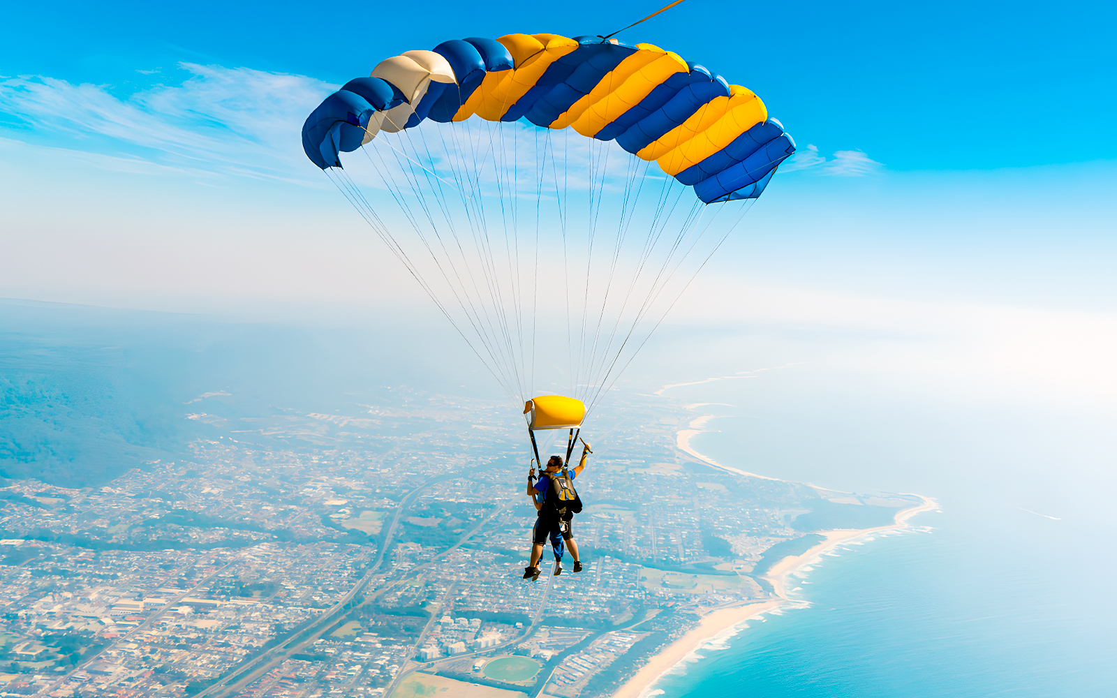 An instructor and a guest skydiving over Wollongong