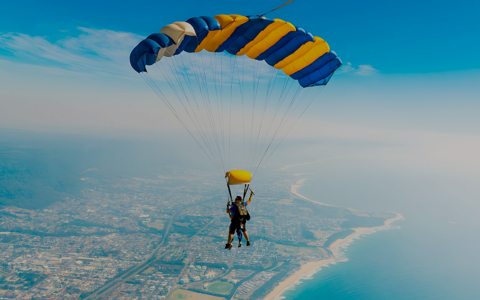 An instructor and a guest skydiving over Wollongong