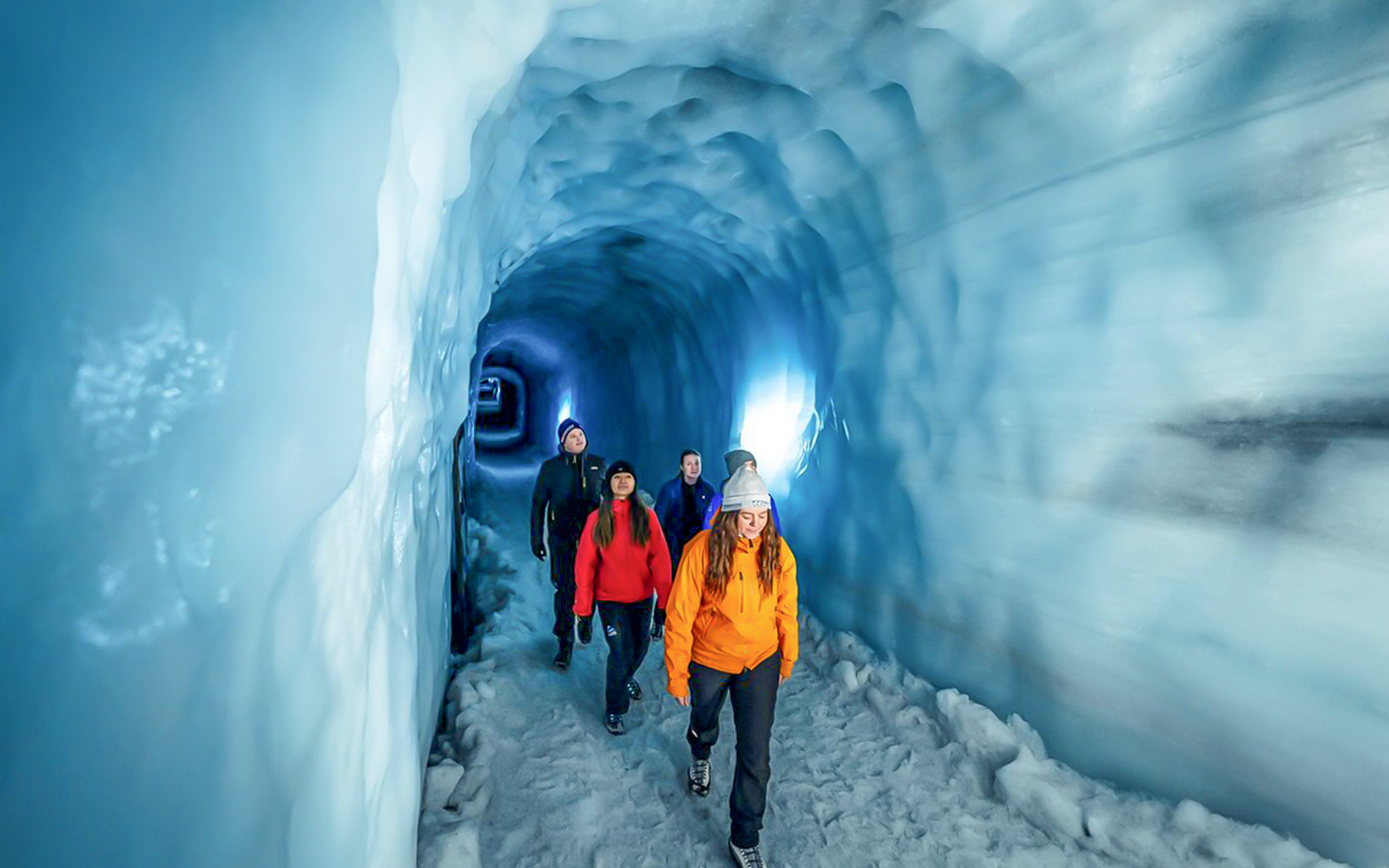 Guests walking through the Ice Tunnel in Langjökull Glacier, Iceland.