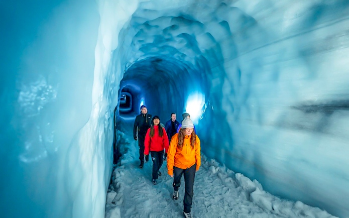 Guests walking through the Ice Tunnel in Langjökull Glacier, Iceland.