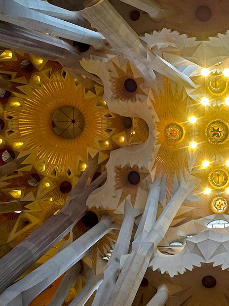 Sagrada Familia interior with Gaudi's intricate columns and stained glass windows, Barcelona.