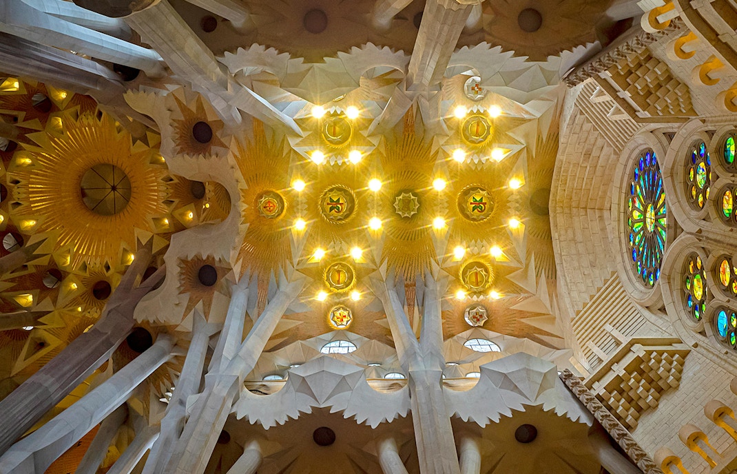 Sagrada Familia interior with Gaudi's intricate columns and stained glass windows, Barcelona.